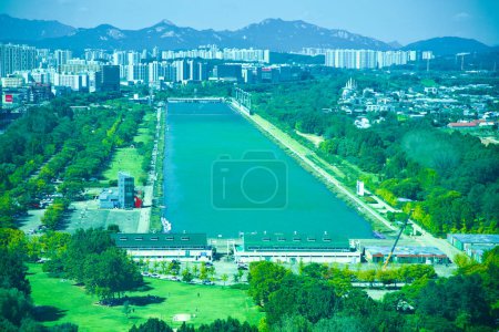 Photo for Hanam City, South Korea - October 1, 2023: An aerial view from Hanam Union Tower captures the Misa Boat Race Park, showcasing the long rectangular artificial lake, a former Olympic venue. - Royalty Free Image