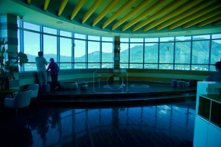 Photo for Hanam City, South Korea - October 1, 2023: Visitors gaze out from the wraparound windows of Hanam Union Tower's viewing deck, with Yebongsan Mountain majestically rising in the background. - Royalty Free Image