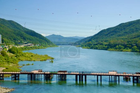 Photo for Hanam City, South Korea - October 1, 2023: Captivating view up the Han River from Paldang Bridge, showcasing a lush valley, Paldang Dam, and a construction bridge. - Royalty Free Image