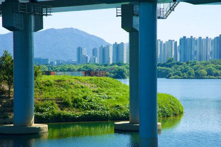 Photo for Guri City, South Korea - September 30, 2023: Overlooking Namyangju Hangang Sports Park, with the serene Wangsuk Stream in the foreground and the striking silhouette of Hanam City's apartment buildings across the Han River. - Royalty Free Image