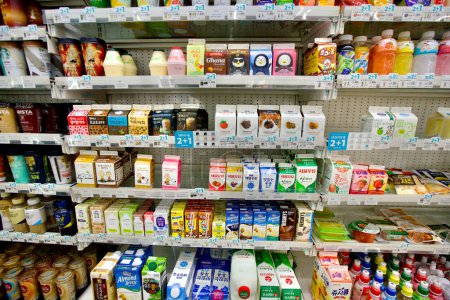 Photo for Ulsan, South Korea - March 3, 2020: An inviting dairy section in a convenience store, featuring chocolate milk, strawberry milk, and banana milk, with coffee drinks on the left and juices on the right. - Royalty Free Image