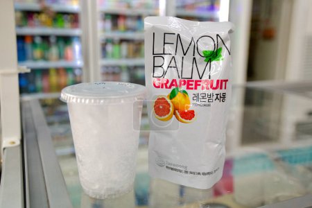 Photo for Ulsan, South Korea - March 3, 2020: A refreshing grapefruit drink in a bag, sold in a convenience store, designed to be poured over a cup of ice, offering a novel and convenient way to enjoy a chilled beverage. - Royalty Free Image