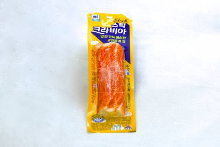 Photo for Ulsan, South Korea - January 14, 2024: Bright yellow packaging encases delicious red crab meat, a convenient and tasty seafood option from a local convenience store, set against a white background. - Royalty Free Image