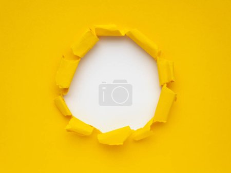 Yellow torn paper on white background. Breaking paper effect.