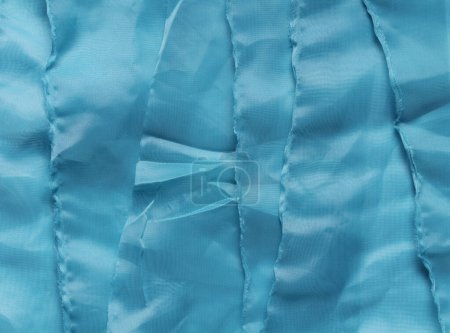 Texture of blue structural fabrics stacked on top of each other.