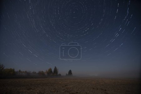Movement of stars in the sky. Photo in the night field.