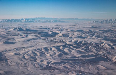 Photo for The sky with clouds and mountains in snow. Photo taken from an airplane. - Royalty Free Image
