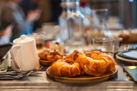 Breakfast table with croissants. Tasty morning food. Business meeting break.