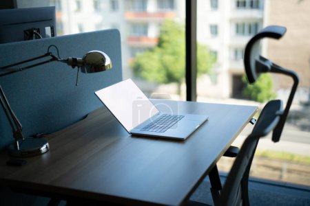 Photo for Laptop standing on an office table. Empty screen mockup - Royalty Free Image