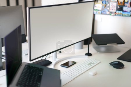 Photo for Empty computer monitors. Screen mockup. Home office studio. Workplace interior. - Royalty Free Image