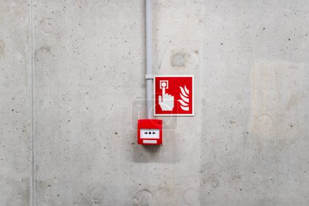 Fire alarm red button. Concrete wall. Emergency alarm.