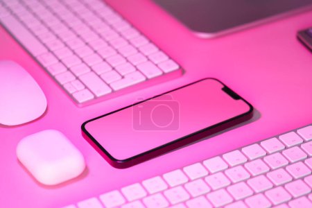 Photo for Smart phone empty screen mockup. Electronic office devices on pink background. - Royalty Free Image
