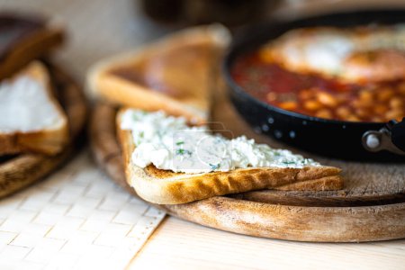 Photo for Warm breakfast. Shakshuka with egg and beans. Bread and toast. - Royalty Free Image