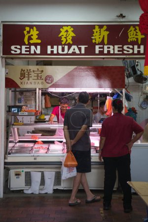 Photo for Singapore - September 28, 2022: Customers shopping at a local wet market butcher stall in HDB block 846 in Yishun Ring Road. - Royalty Free Image