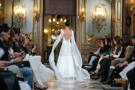 Photo for Model showcases creations by  INMACULADA RODRIGUES during the Atelier Couture bridal catwalk within Madrid Fashion Week, at Santa Isabel Palace in Madrid. marzo, 2024 Spain - Royalty Free Image