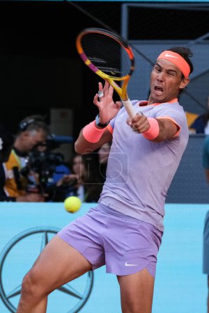 Photo for Rafael Nadal of Spain in action against Darwin Blanch on Day Three during their second round match of the Mutua Madrid Open at La Caja Magica on April 25, 2024 in Madrid, Spain - Royalty Free Image