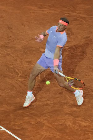 Photo for Rafael Nadal of Spain  against Alex de Minaur in the Men's Singles Round of 64 match during Day Five of the Mutua Madrid Open at La Caja Magica on April 27, 2024 in Madrid, Spain. - Royalty Free Image