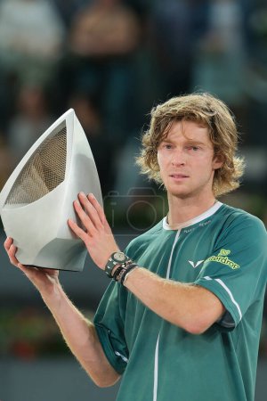 Photo for Andrey Rublev poses with the Mutua Madrid Open trophy following victory in the Men's Singles Final match against Felix Auger  of Mutua Madrid Open at La Caja Magica on May 05, 2024 in Madrid, Spain. - Royalty Free Image