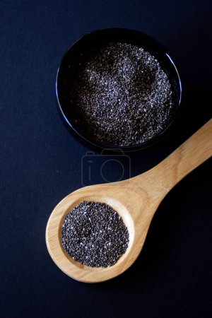 Healthy grains.Close-up photo.with dark background.Chia grains, source of vitamins and omega-3.