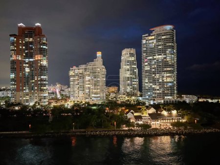 Night landscape from the sea.American tourism concept.Miami city waterfront. Iluminated buildings