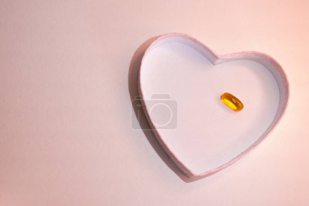 Graphic resource to promote body care and health.Concept of heart care. Horizontal top view photo with space for copy on pastel pink background.