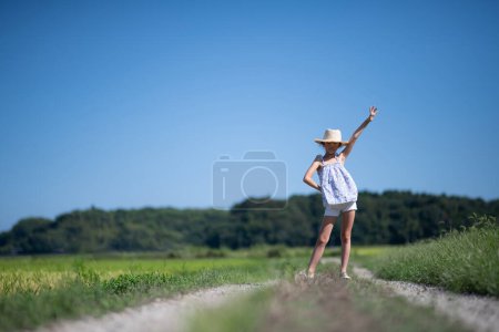 Photo for Young asian girl  having fun raising hand  in countryside - Royalty Free Image