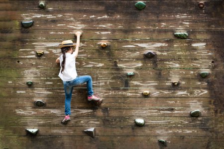 Photo for Girl to challenge the bouldering - Royalty Free Image