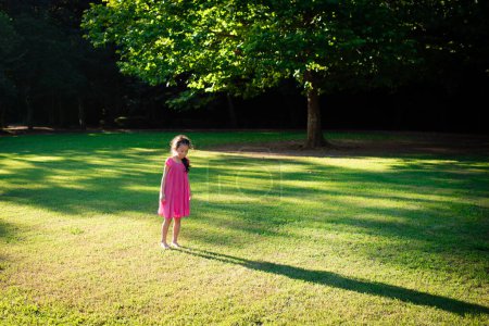 Photo for Girl playing barefoot on meadow - Royalty Free Image