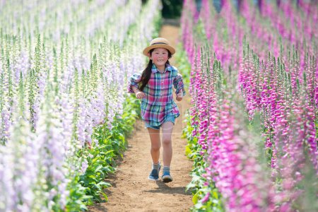 Photo for Girl playing in the flower field - Royalty Free Image
