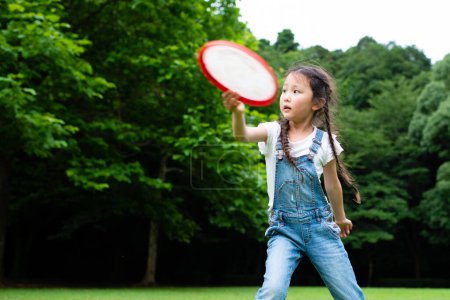 Photo for Girl playing with flying disc - Royalty Free Image