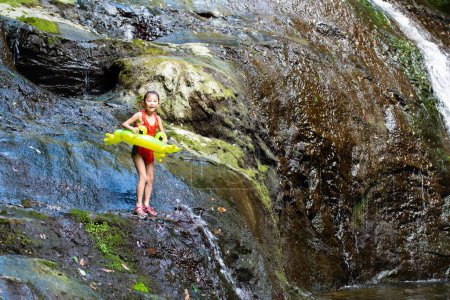 Téléchargez les photos : Enfant sautant dans un trou d'eau - en image libre de droit