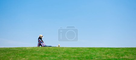Photo for Woman sitting in the meadow - Royalty Free Image