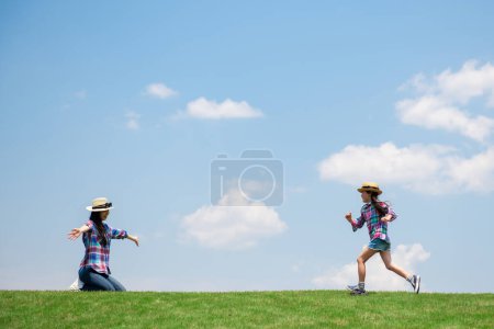 Photo for Mother and daughter playing in the meadow - Royalty Free Image