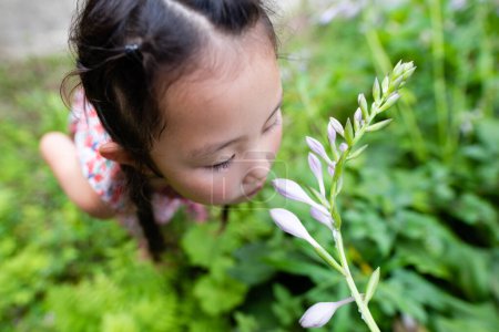 Photo for Girl smelling the smell of flowers - Royalty Free Image