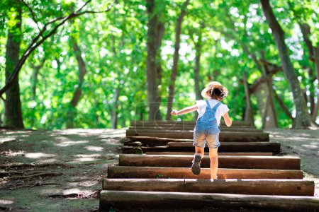 Photo for Child going up the stairs in the forest - Royalty Free Image
