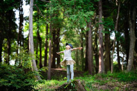 Photo for Girl taking deep breath in the woods - Royalty Free Image