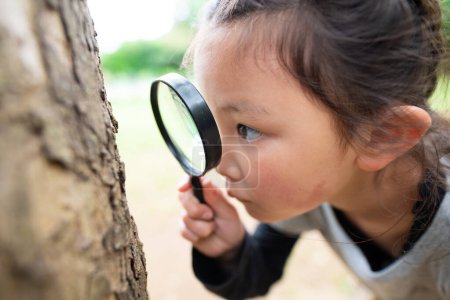 Photo for Girl looking with magnifying glass - Royalty Free Image