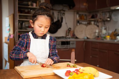 Téléchargez les photos : Fille faisant gâteau sur la cuisine - en image libre de droit