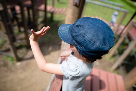 Photo for Girl waving hand in the park - Royalty Free Image