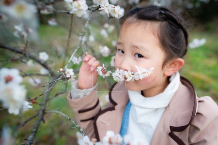 Photo for Girl to see the plum blossom - Royalty Free Image