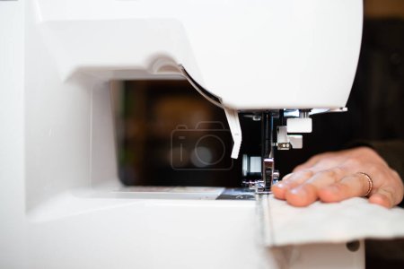 Photo for A woman operating a sewing machine - Royalty Free Image
