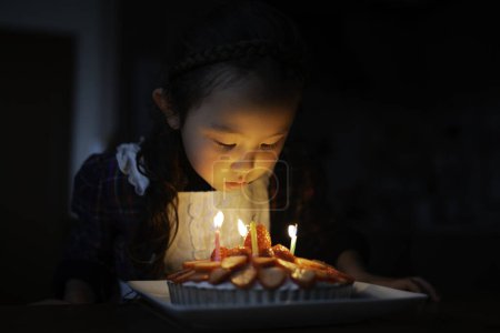 Photo for Girl blow out the candle of cake - Royalty Free Image