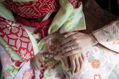 Photo for Hands of parent and child wearing kimono - Royalty Free Image