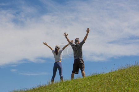 Téléchargez les photos : Un couple faisant de l'exercice sur la pelouse - en image libre de droit
