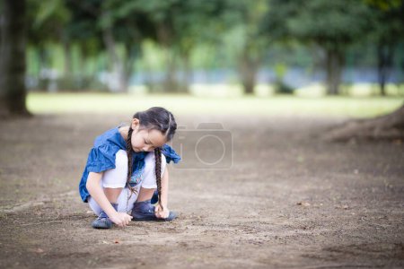 Photo for Girl drawing a picture on the ground - Royalty Free Image