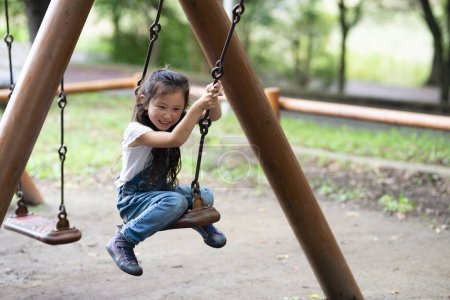 Photo for Girl playing in the swing - Royalty Free Image