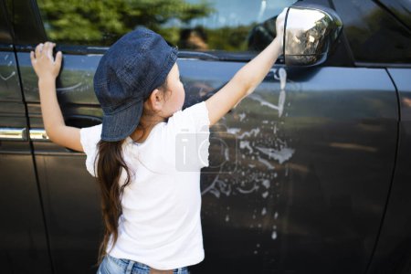 Photo for Girl washing the car - Royalty Free Image