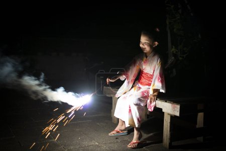 Photo for Girl wearing a yukata to the fireworks - Royalty Free Image