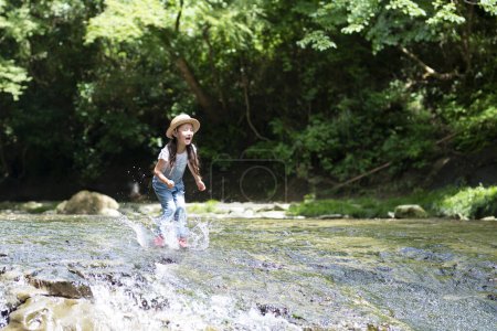 Photo for Girl playing in the river - Royalty Free Image