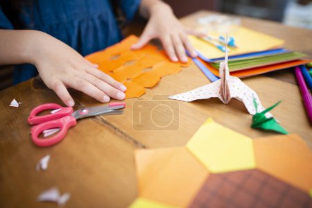 Photo for Girl playing with origami - Royalty Free Image